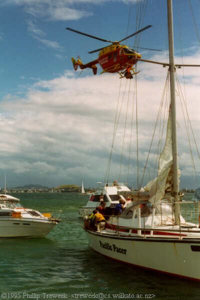 A paramedic can be seen on the helicopters port skid preparing to winch down to attend to the lad.  